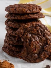 Brownie cookies stacked on top of each other with one that has a bite taken out of it