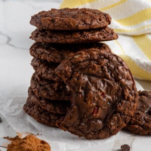 Brownie cookies stacked on top of each other with one that has a bite taken out of it