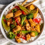 Overhead look of honey garlic chicken stir fry in a bowl over rice.