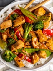 Overhead look of honey garlic chicken stir fry in a bowl over rice.