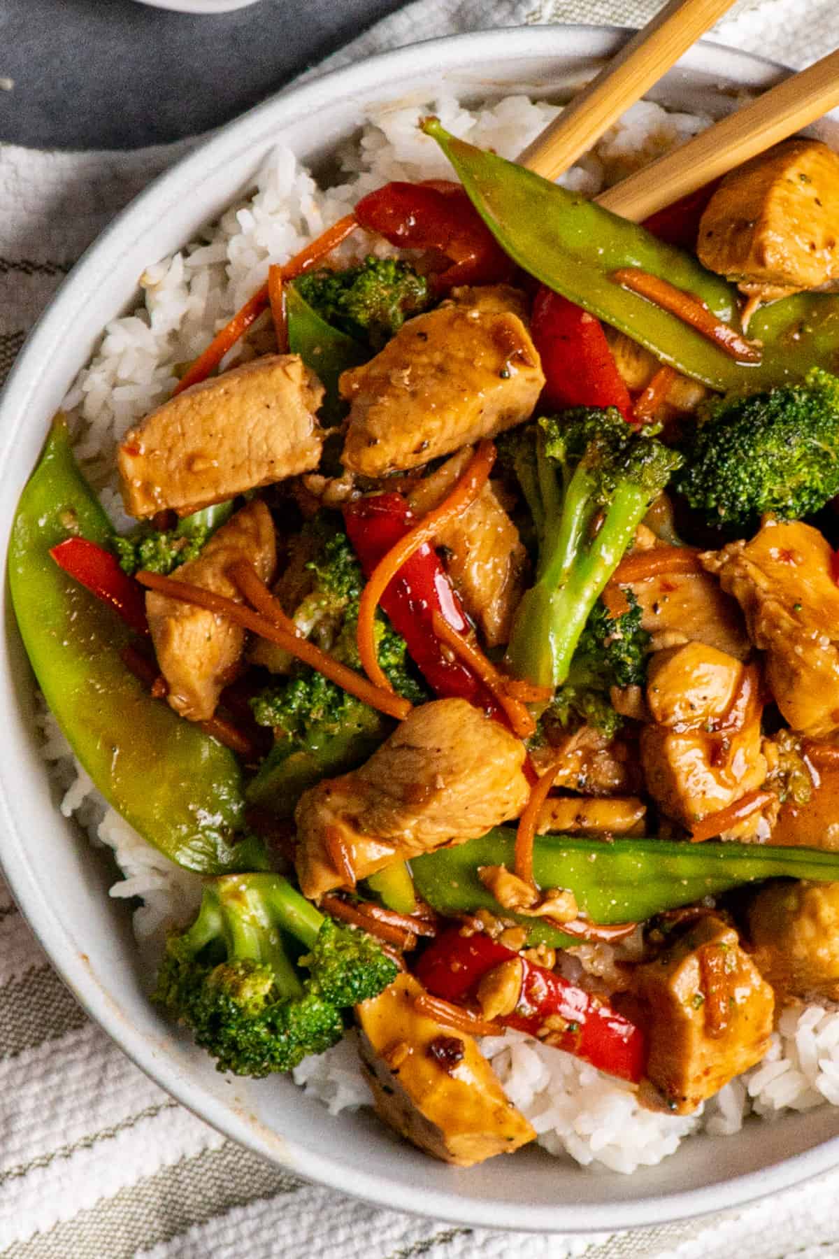 Overhead look of honey garlic chicken stir fry in a bowl over rice