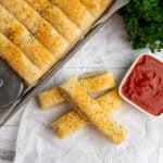 Overhead look at sheet pan breadsicks on parchment paper