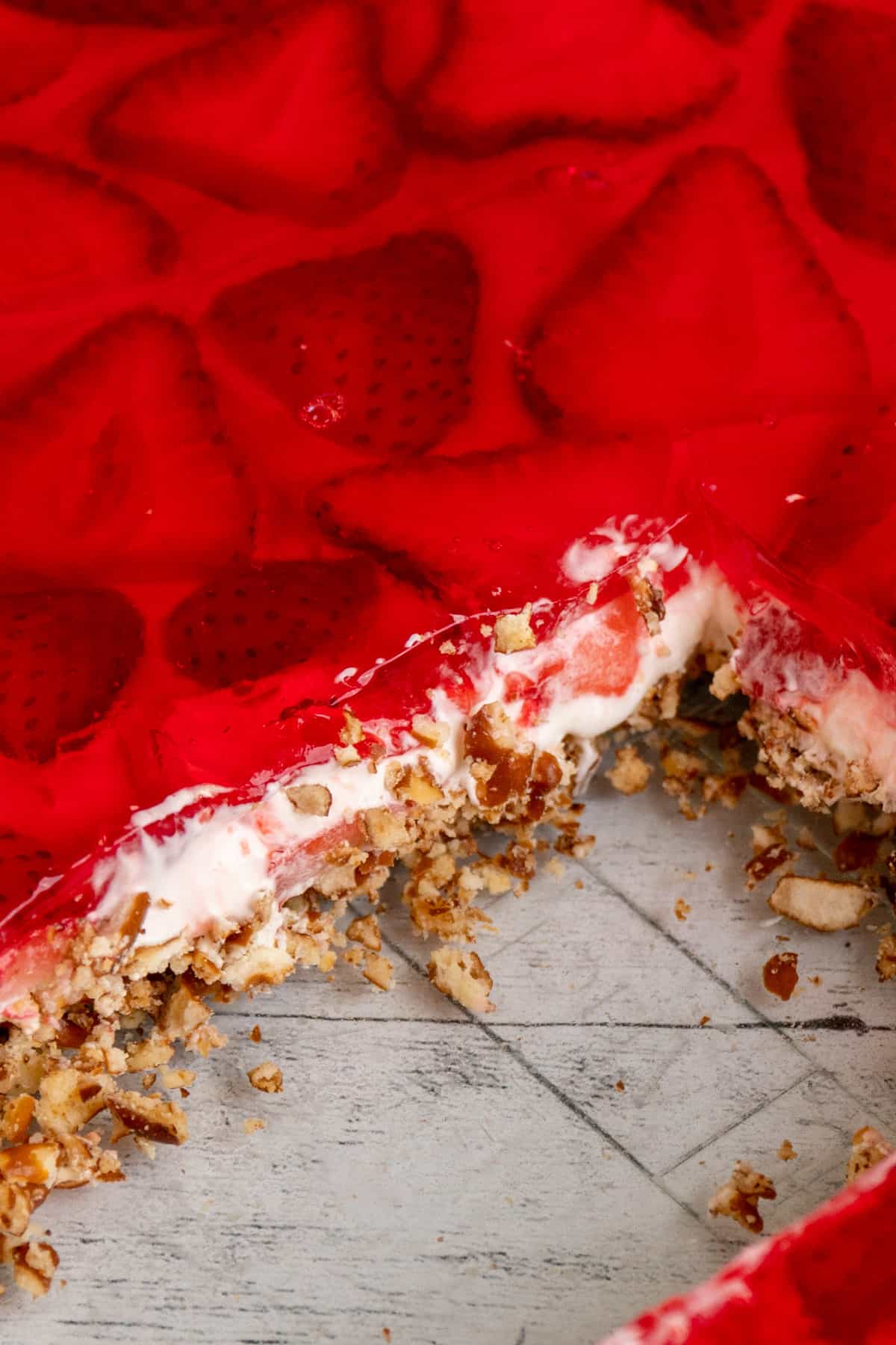 Close up of strawberry pretzel salad in a clear baking dish