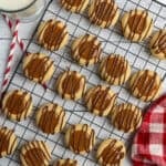 Overhead look at Twix thumbprint cookies on a cooking rack