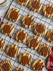 Overhead look at Twix thumbprint cookies on a cooking rack