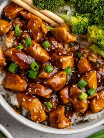 A bowl of honey teriyaki chicken over rice with broccoli