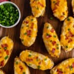 Overhead look at the best twice baked potatoes garnished with bacon and green onions.