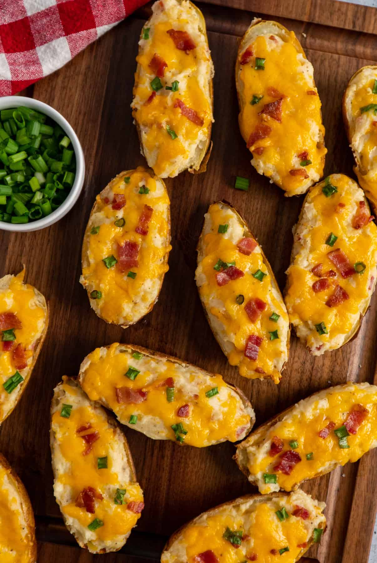 Overhead look at the best twice baked potatoes garnished with bacon and green onions.