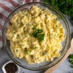 Mustard potato salad recipe in a clear bowl.