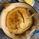 Overhead look at no knead Dutch oven bread on parchment paper.