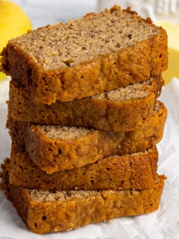 The best banana bread recipe sliced and stacked on top of each other.