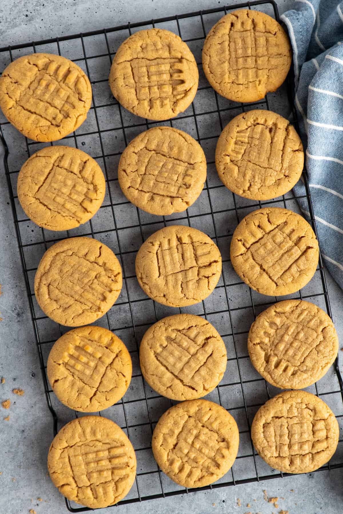 Peanut butter cookies on wire cooling rack.