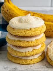 Frosted banana cookies stacked on top of each other.