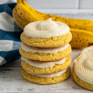 Frosted banana cookies stacked on top of each other.