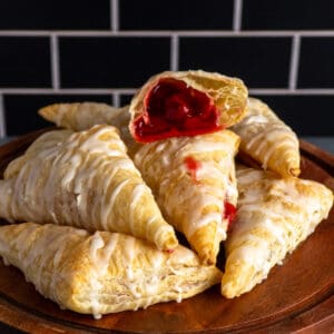 Close-up of homemade cherry turnovers on a cake stand.