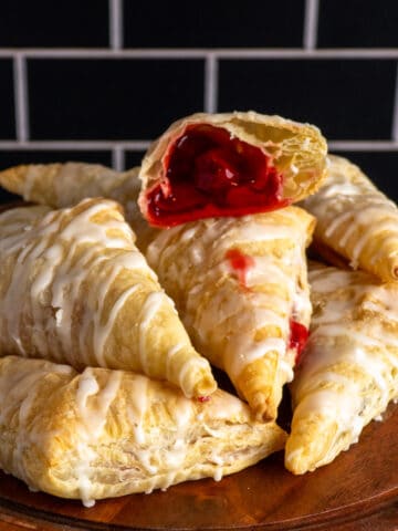 Close-up of homemade cherry turnovers on a cake stand.