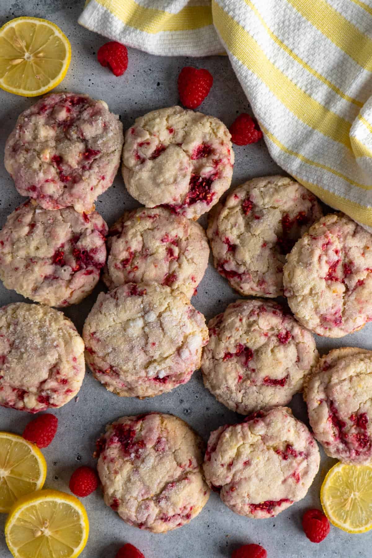 Raspberry lemonade cookies spread out on a concrete background.