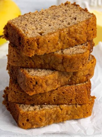 The best banana bread recipe sliced and stacked on top of each other.