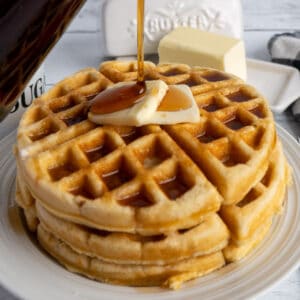 The best homemade waffle recipe with syrup being poured on it.