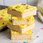 Four frosted sugar cookie bars stacked on top of each other