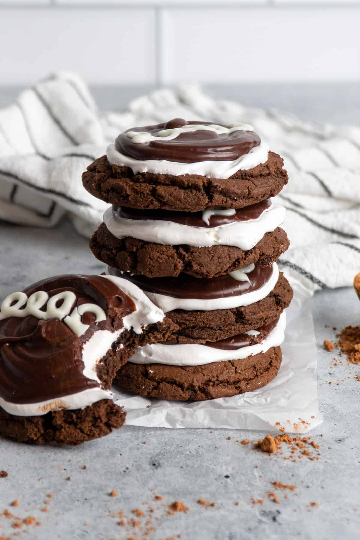 Chocolate and marshmallow cookies stacked on top of each other.