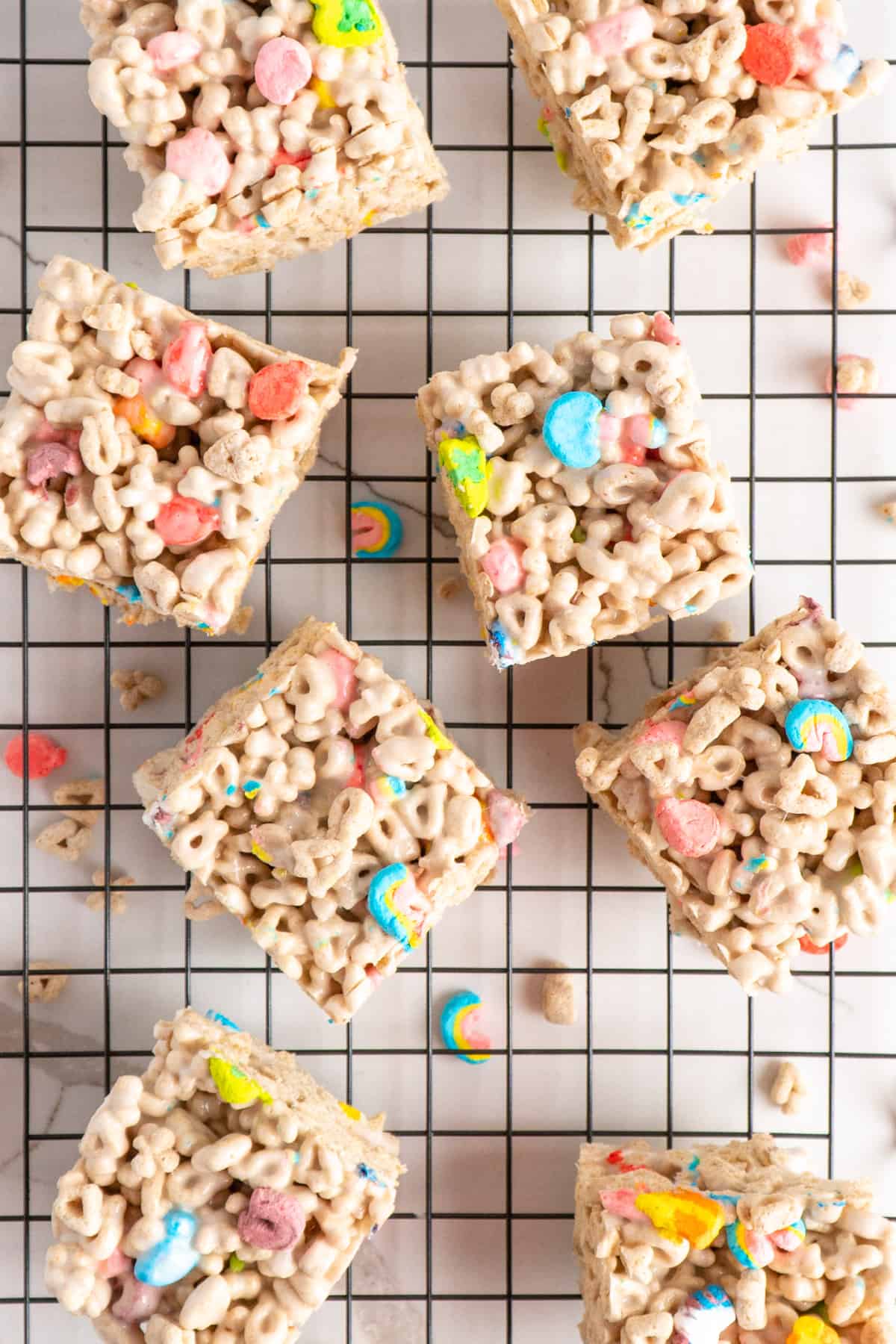 Lucky charm rice krispie treats a black wire cooling rack.