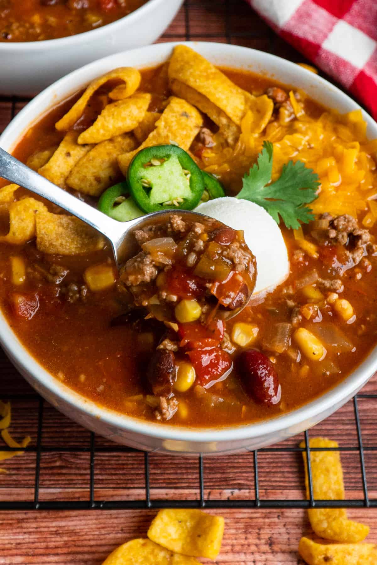 A spoon holding a bite of taco soup.