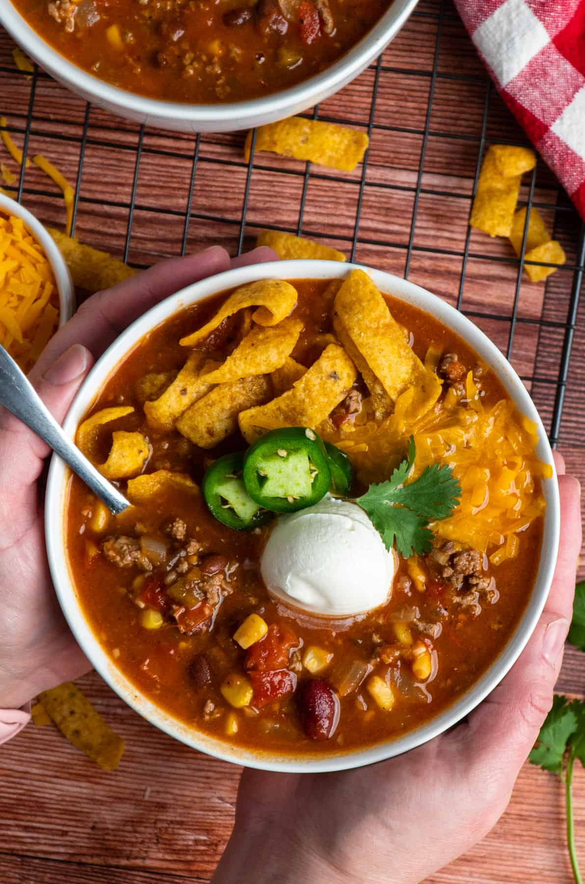 Hands holding a bowl of taco soup.
