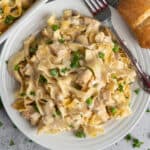 Overhead look at chicken noodle casserole on a plate and in a baking dish.