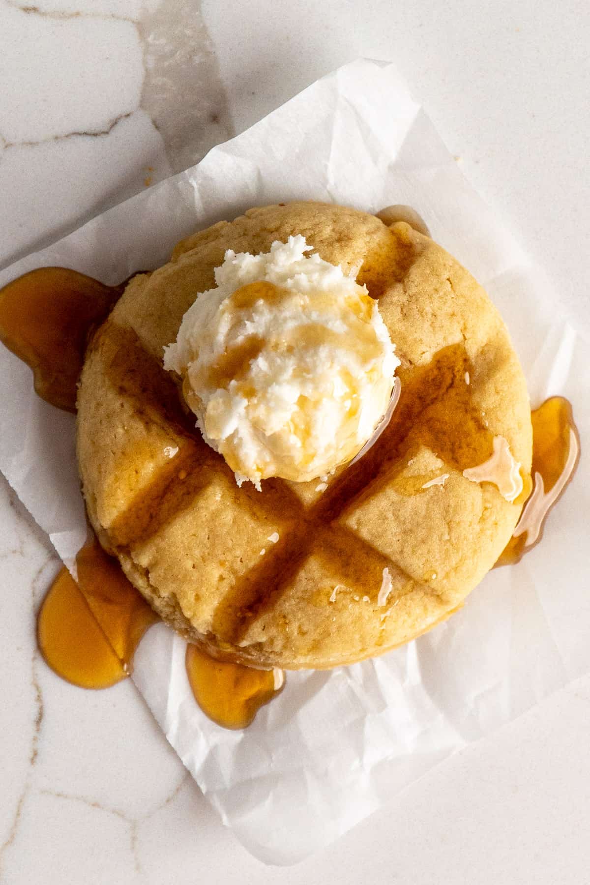 A Crumbl waffle cookie with syrup on it.