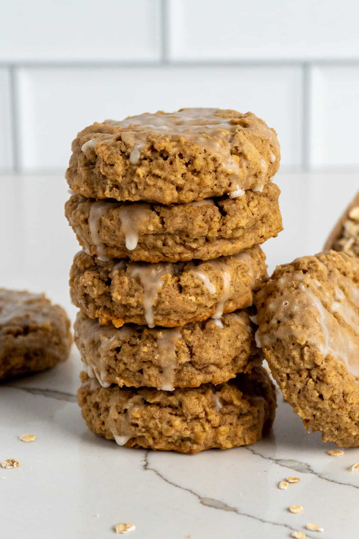 Five iced oatmeal cookies stacked on top of each other.
