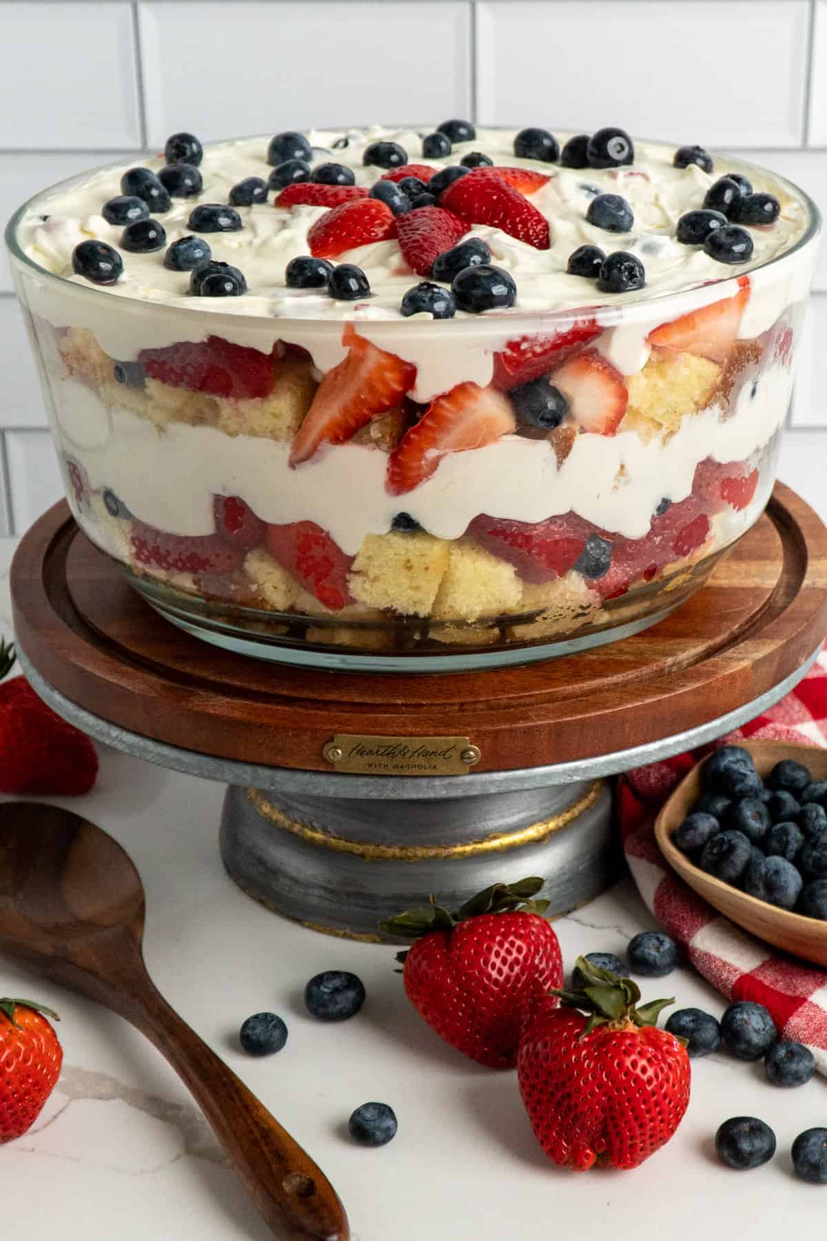 Strawberry and blueberry pound cake trifle on a stand.