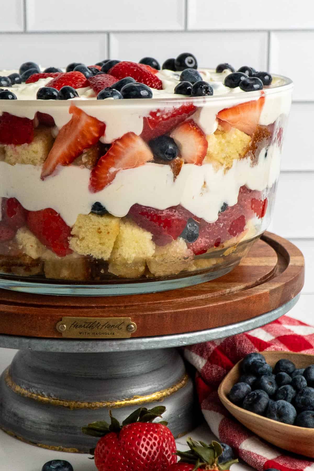 Close-up of strawberry and blueberry pound cake trifle on a stand.