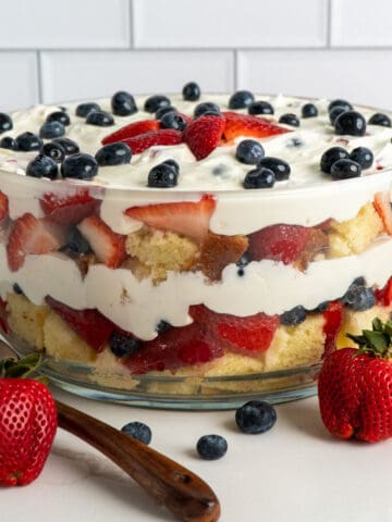 Strawberry and blueberry pound cake trifle in a glass bowl.