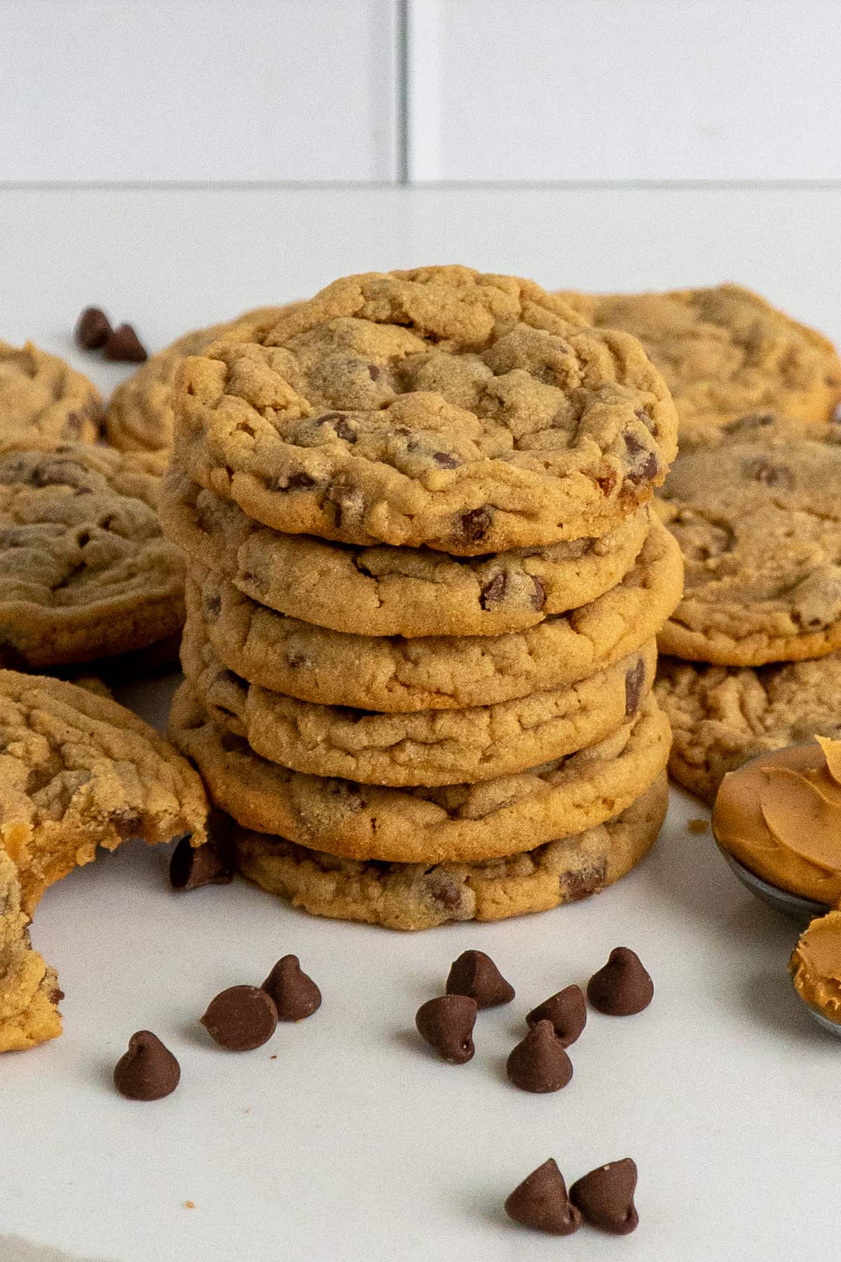 Six peanut butter chocolate chip cookies stacked on top of each other.