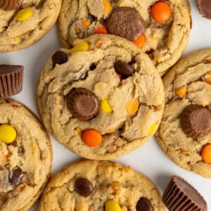 Reese's pieces cookies stacked on top of each other on a white background.