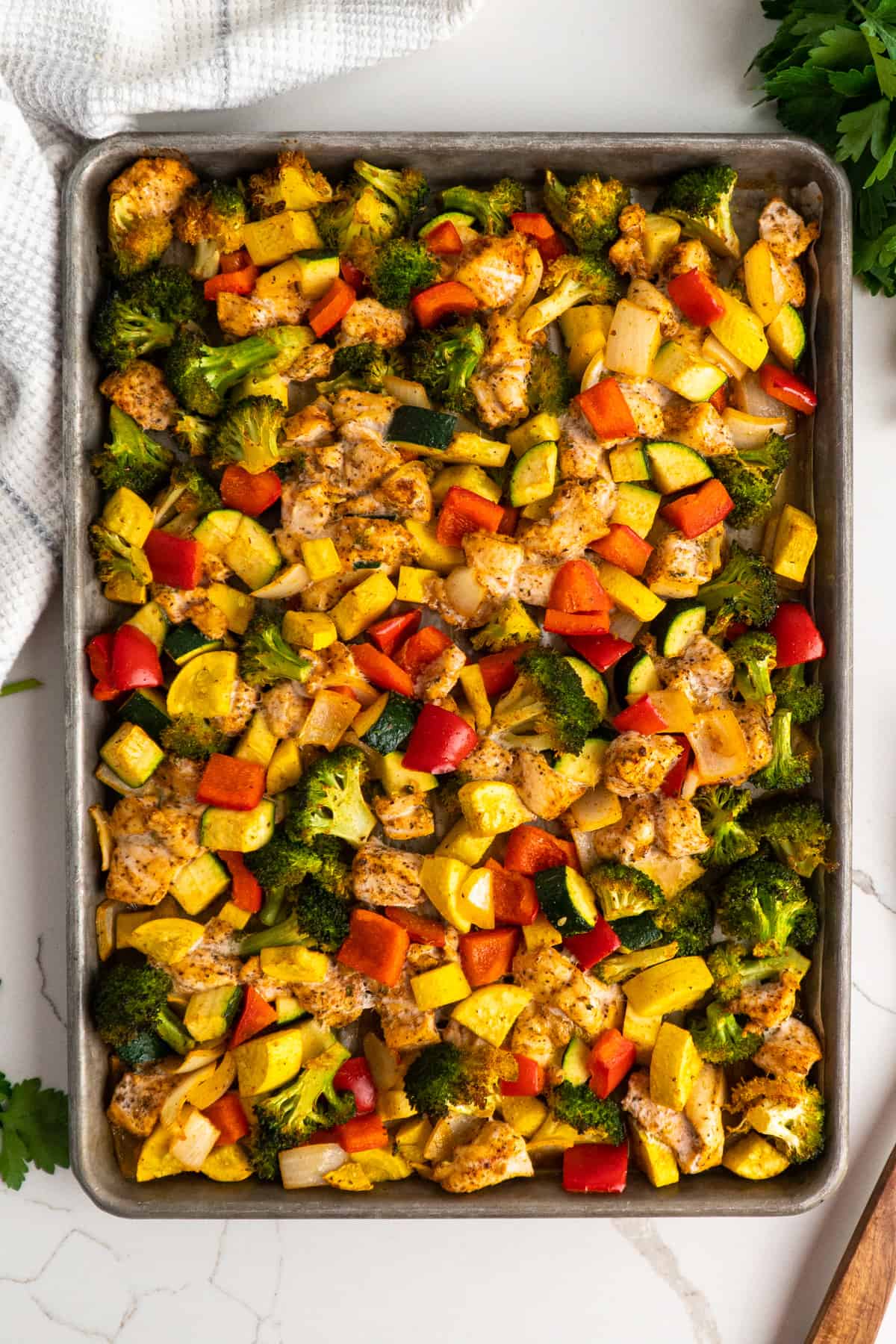 Overhead look at oven-roasted sheet pan chicken and veggies.