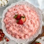 Overhead, look at strawberry fluff salad in a white bowl.