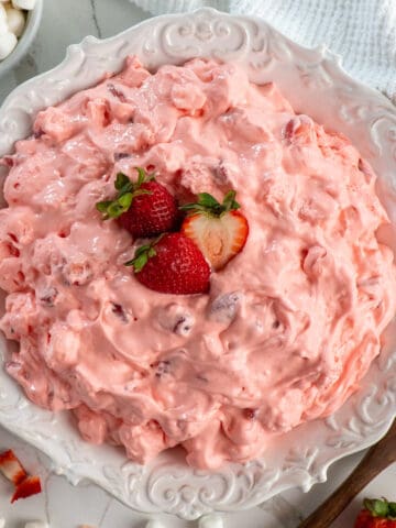 Overhead, look at strawberry fluff salad in a white bowl.
