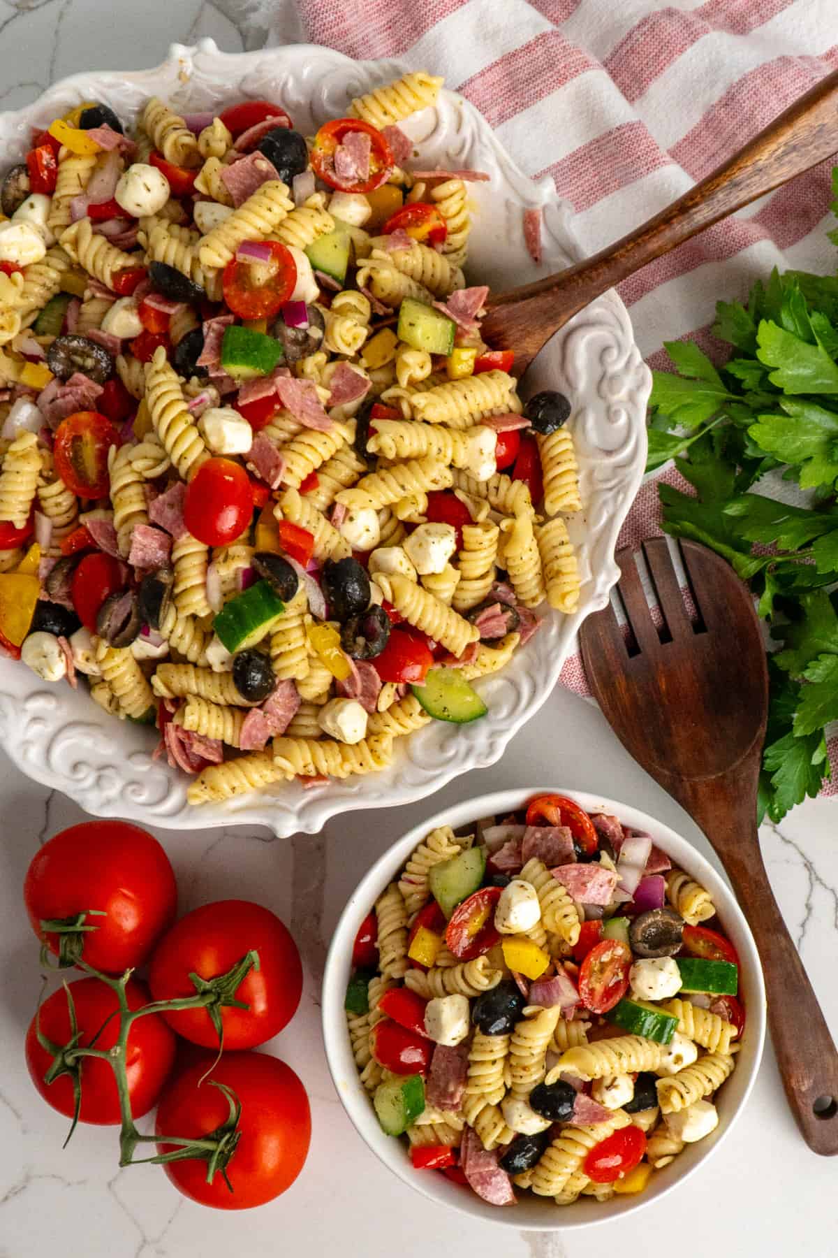 Italian pasta salad in a small bowl and a big bowl.
