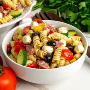 Close-up of Italian pasta salad in a small white bowl.