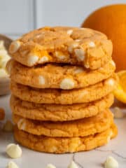 Six orange creamsicle cookies stacked on top of each other.