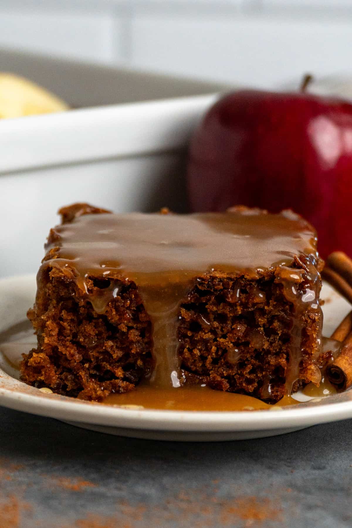Close-up of caramel apple cake on a white plate.