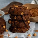 Four chocolate peanut butter chip cookies stacked on top of each other.