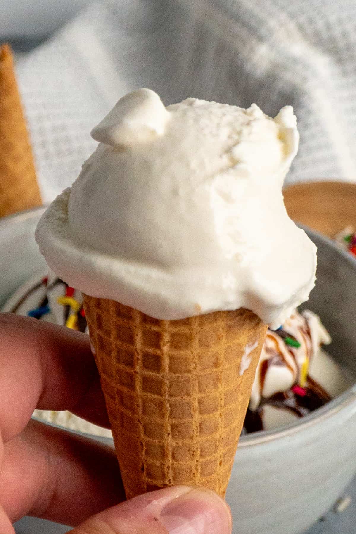 Homemade vanilla ice cream on a sugar waffle cone.