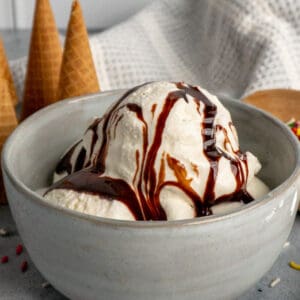 Homemade vanilla ice cream with chocolate sauce over the top.