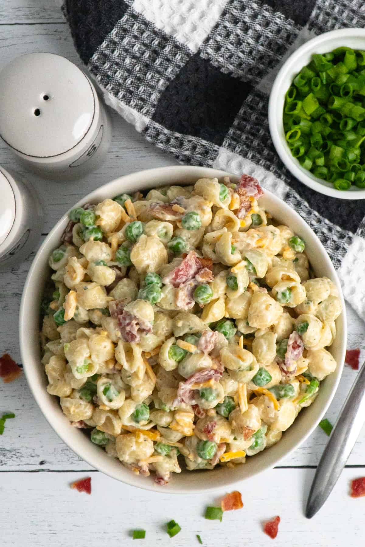Overhead look at creamy pea pasta salad with bacon and cheese.