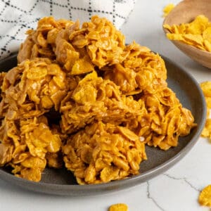 Close-up of peanut butter cornflake cookies on a plate.
