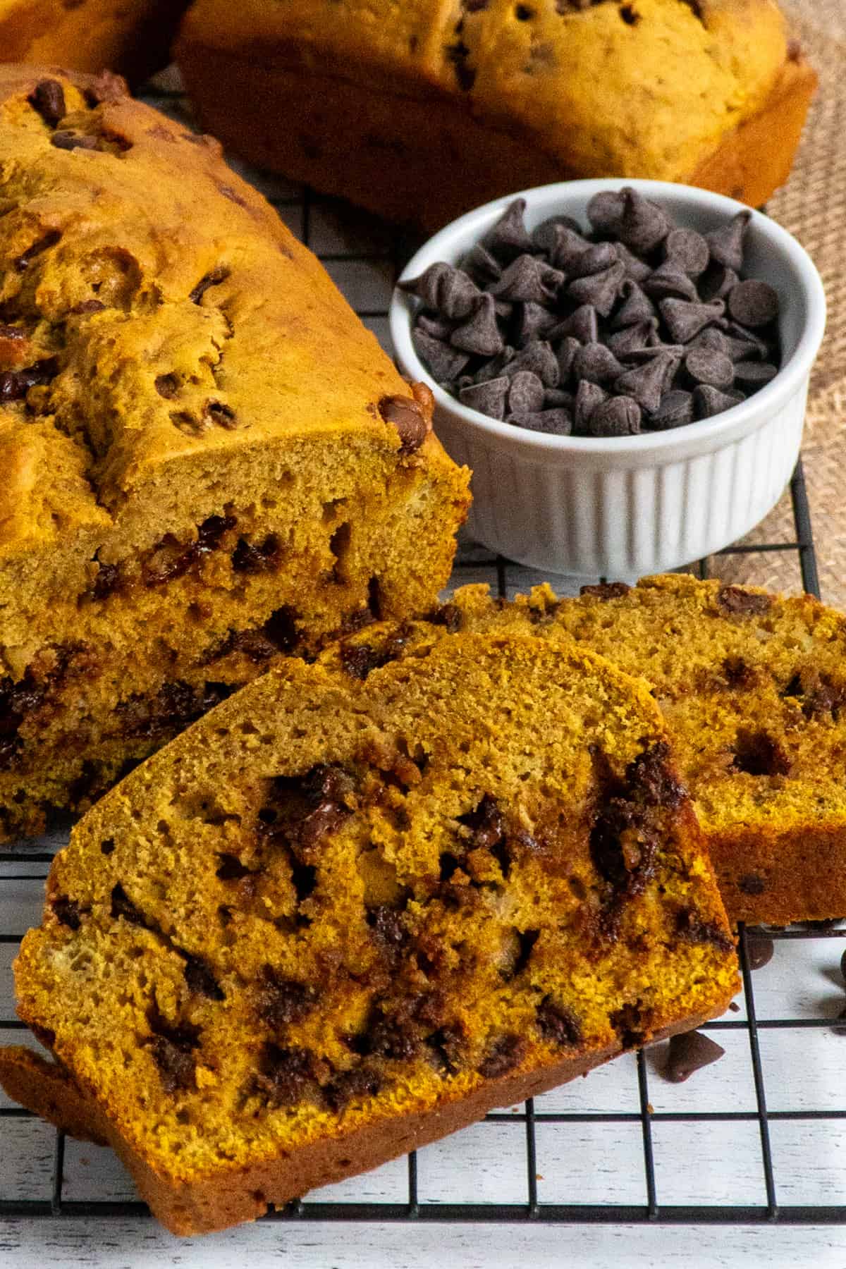 Close-up of pumpkin banana bread on a cooling rack to show off the inside.