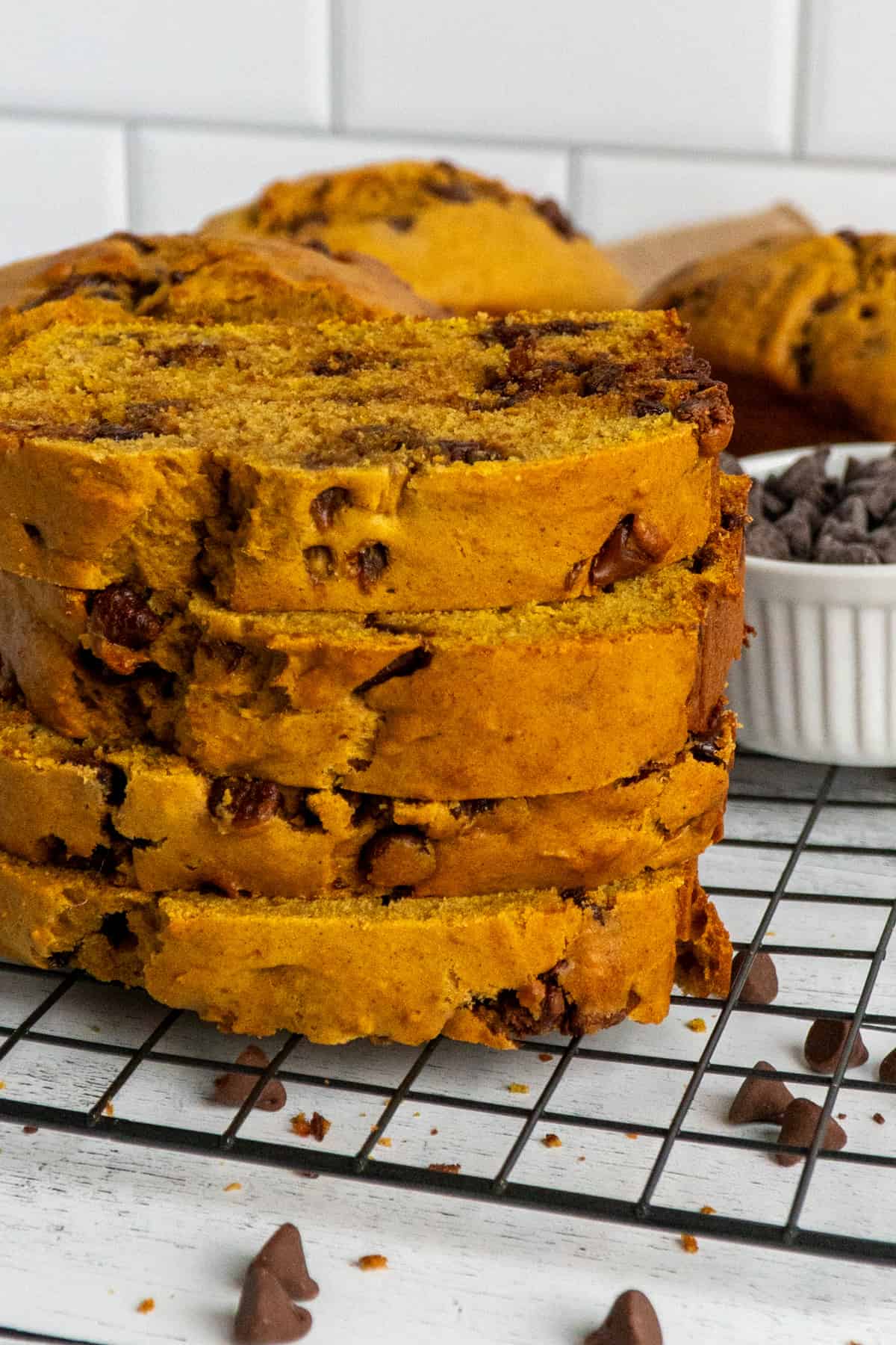 Four pieces of pumpkin bread stacked on top of each other.